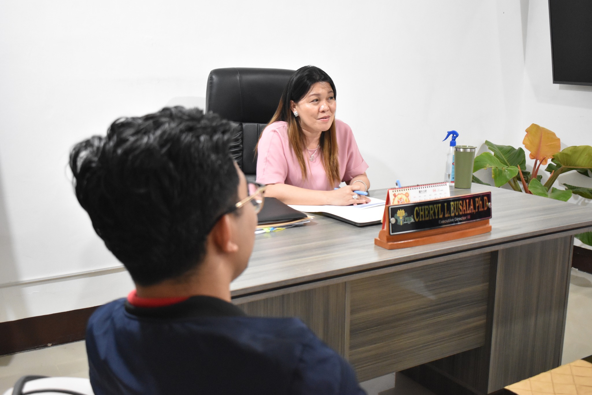 May be an image of 2 people, people studying, table and text