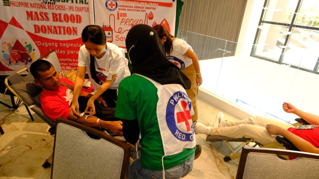 May be an image of 4 people, clothes iron and text that says "PIHIPPINE-RFD-GROSC AMBOANGA SIBEGAY (HAPTER BLOODE COLLECTING UNTI am PROUDl PHILPINENATONIALREDCROS-PLHAER CROSS IPIL CHAPTER MASSBLOOD MASS BLOOD DONATION "Dugongnagmula "Dugong nagmula alay para HOSPITALin PINENATIO 17,2024 Sav P PHLAT HIL RED RED"